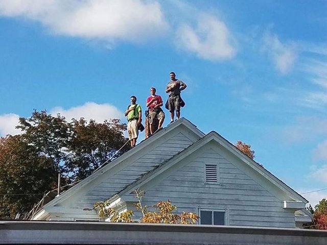 3 roofers set hammers aside to stand for National Anthem